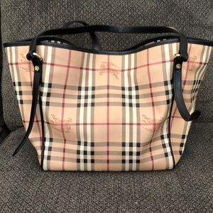 Burberry Tote with black trim/shoulder straps and brass hardware.